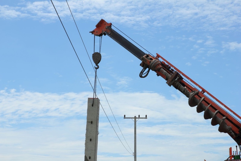 a concrete power pole being installed